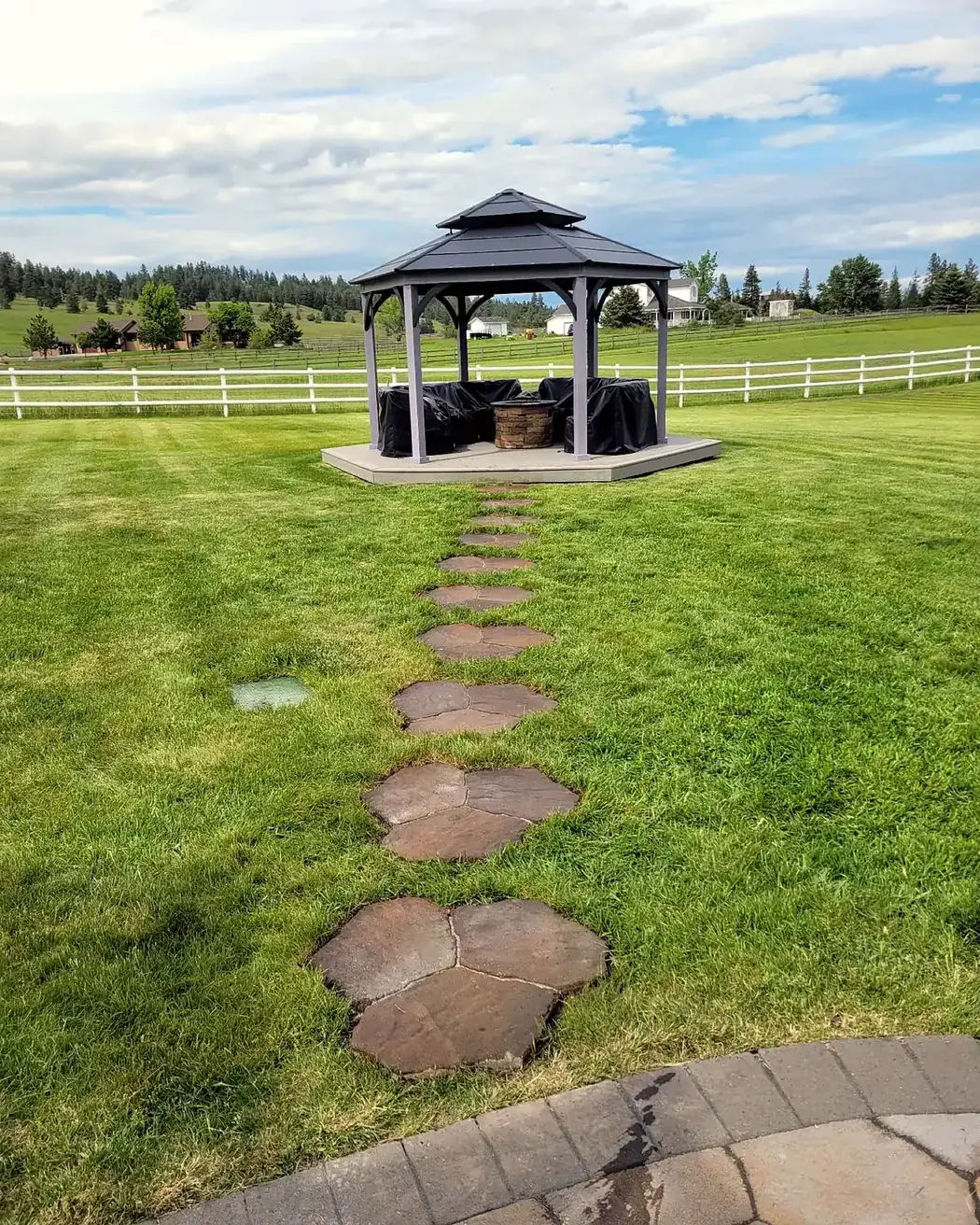 Freshly installed sod lawn around a backyard gazebo