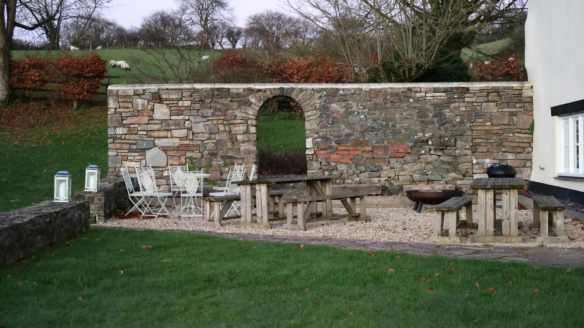 Stone garden wall with lawn and shrubs