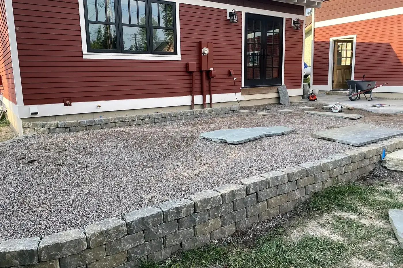 Natural stone retaining wall on a sloped property